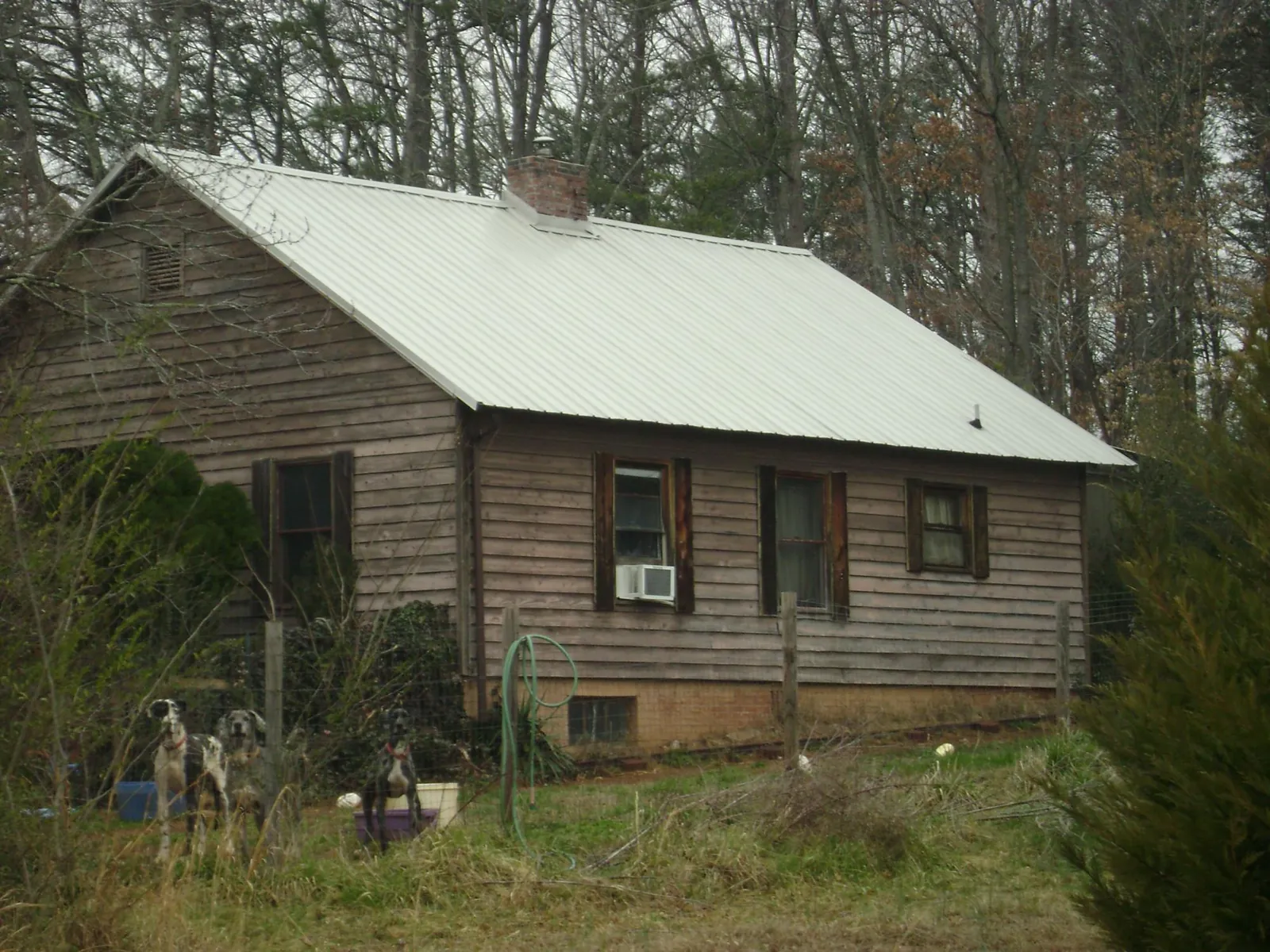 White metal roof on an old wood sided farmhouse, from a Metal Roof Installation job in Reidville